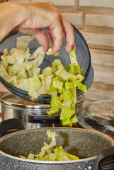 Sticker - Chef is throwing lettuce in pot on gas stove