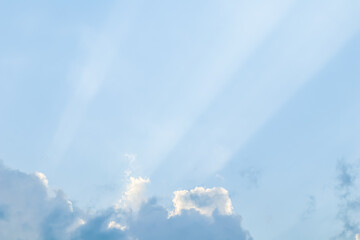Wall Mural - background from blue sky with sun rays across clouds