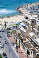 Buildings and road with cars near sea shore