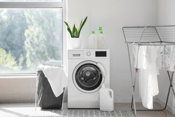 Wall Mural - Interior of light laundry room with washing machine, basket and dryer