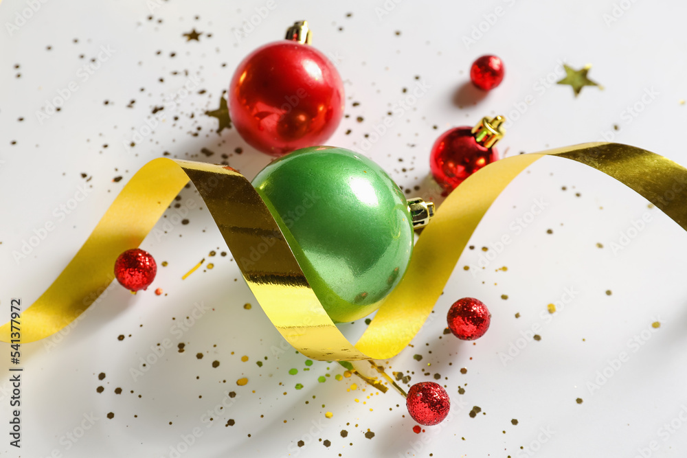 Composition with Christmas balls and serpentine on white background, closeup