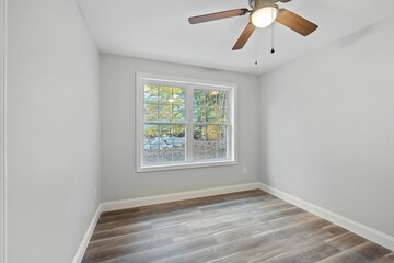 Sticker - Modern ranch home interior design with an empty room with white walls and a ceiling fan with lights