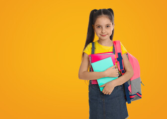 Poster - Little girl with school stationery on yellow background, space for text