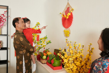 Wall Mural - Grandfather Showing Tet Decorations