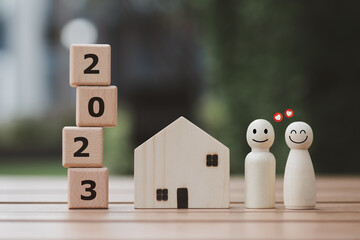 2023 Happy New Year. Happy family, Budget planning, Insurance, House and Real estate, Plan and saving money for future. Human figure two couple with smiling face and heart with wood block number 2023.