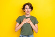 Portrait of negative unhappy woman with bob hairdo dressed khaki t-shirt hands on chest blaming look isolated on yellow color background