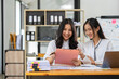 © crizzystudio - Asian female sales representatives in the section of Real estate talked and discussed tax plans to search for information Ask questions and give advice. All information is recorded and detailed.