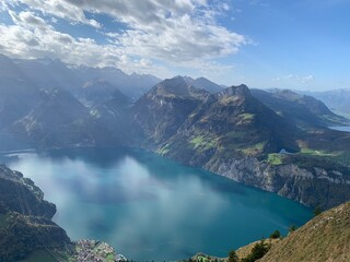 Wall Mural - lake and mountains with sun rays shining upon it from the sky, stoos switzerland