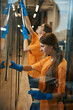 © Viacheslav Yakobchuk - Two cleaners are cleaning the large windows of a coworking space