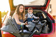 © Marc Calleja - mother with her son behind the car preparing the trip
