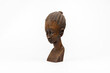 Wooden figurine of an African woman isolated on white background, left view