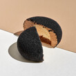 Mini mousse pastry dessert covered with chocolate velour on a light background. Modern european cake.