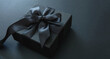 Black Friday Sale. Gift box with black ribbon isolated on black, close up