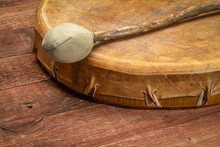 Handmade, Native American Style, Shaman Frame Drum Covered By Goat Skin With A Beater Against Rustic Wood