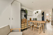 © ADDICTIVE STOCK - Modern Home With table and chairs next to dining room