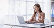 © David - Cheerful Asian female business entrepreneur professional working on laptop while sitting in workplace office desk, business asian woman do Documents, tax, report analysis Savings, finances economy.