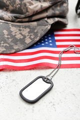 Wall Mural - Military tag, cap and national flag of USA on light background, closeup