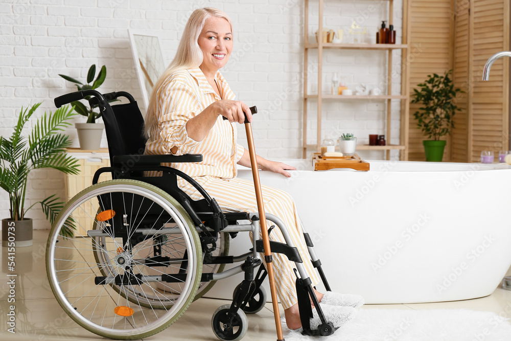 Mature woman with physical disability going to take bath at home
