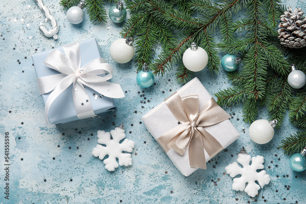 Composition with fir branches, Christmas gifts and decorations on color background