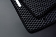 New black car mats made from eva ethylene vinyl acetate. Close up view.