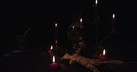 Canvas Print - Still Life Satanic with steaming sacrificial cup and candles with black background.