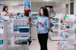 © DC Studio - Pharmacy client checking medication and pills boxes to buy prescription treatment, looking at pharmaceutical products. Examining drugstore shelves with drugs, packages and medical supplements.