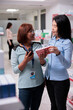 © DC Studio - Customer asking healthcare worker to give medication, looking at cardiology pills box to buy prescription treatment. Reading leaflet of healthcare supplements and medical products.