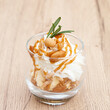 Homemade vanilla ice cream parfait with nutty, caramel sauce, whipped cream and cookie crumble