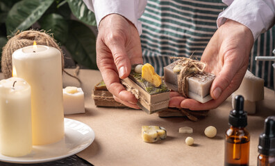 Beautiful natural handmade soap, packed in kraft paper and tied with a ribbon. Concept of an interesting hobby and useful eco friendly organic gifts