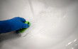 © Svetliy - Cleaning the white ceramic sink in the bathroom. A hand in a blue glove cleans the sink. Removal of limescale. Disinfection in the bathroom. House cleaning clearing agency.