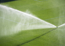 Overhead View Of Sprinklers Watering A Football Pitch, Spain