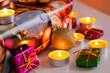 Christmas and New Year composition: burning candles and gift boxes, shallow depth of field