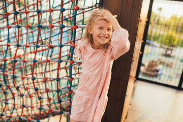 Wall Mural - Cute little girl playing on the playground.