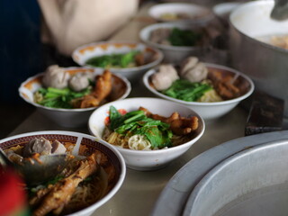 Wall Mural - Selective focus Mie ayam, mi ayam or bakmi ayam indonesian for chicken bakmi, literally chicken noodles, is a common Indonesian dish of seasoned yellow wheat noodles topped with diced chicken meat.