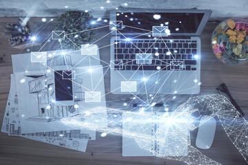 Poster - Envelop hologram drawing over computer on the desktop background. Top view. Double exposure. Technology concept.