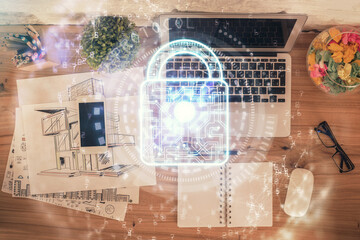 Poster - Double exposure of lock hologram drawing over study table background with computer. Concept of data security. Top view.
