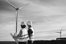 Engineers Working At Alternative Renewable Wind Energy Farm - Eco Sustainable Energy Industry Concept - Black And White Editing