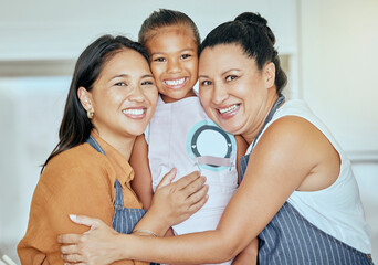 Poster - Mother, girl and grandma in hug kitchen with smile on face and help baking or cooking together. Family, apron and generations, portrait of happy women and child hugging in family home in Indonesia.