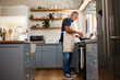 © N Lawrenson/peopleimages.com - Senior man, cooking food and stove kitchen, lunch meal and dinner in frying pan in New Zealand home. Mature house chef with apron make easy recipe, cuisine and fresh diet for dining in retirement