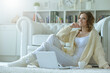 © aletia2011 - Portrait of a beautiful woman with a laptop on the floor