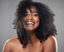 Face, Hair Care And Beauty Smile Of Black Woman On Gray Studio Background. Portrait, Makeup And Female Model From Jamaica With Beautiful, Healthy Head Of Hair And Curls After Spa Cosmetics Treatment