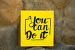 © New Africa - Yellow paper note with phrase You Can Do It on stone background
