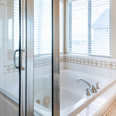 Wall Mural - Square Bathroom interior with bathtub and shower stall with ceramic tiles surround near the windows