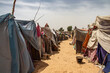 Refugee camp in Africa, full of people who took refuge due to insecurity and armed conflict. People living in very poor conditions, lack of food, clean water and proper shelter to stay in