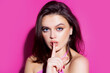 © Volodymyr - Silence. Woman silence or secrecy with finger on lips hush hand gesture on pink background. Pretty girl placing fingers on lips, shh sign symbol. Emotion facial expression.
