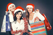 © yurolaitsalbert - group of happy women in costumes of Santa Claus and Christmas shopping .