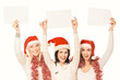 © yurolaitsalbert - group of female students in costumes of Santa Claus holding blank sheets