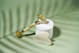 Fototapeta Konie - Green jade face roller and Gua Sha scraping for beauty facial massage therapy