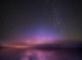 Wall Mural -   night  starry sky  and moon at sea lilac blue nebula cosmic milky way Aurora   seascape