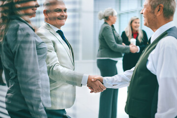 Poster - close up. successful businessman shaking hands with his business colleague.